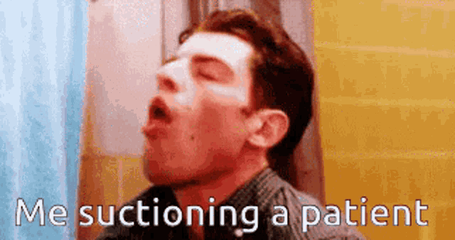 a man with his mouth open is suctioning a patient .