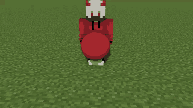 a person in a red hoodie is sitting on the grass