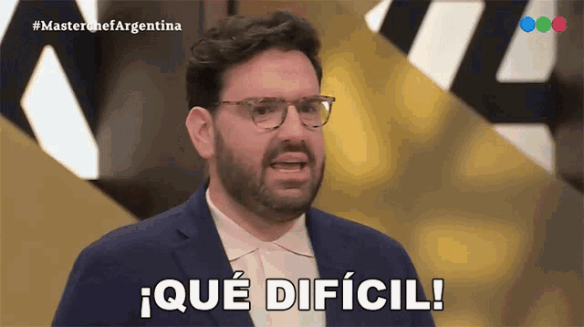 a man with glasses and a beard says " que dificil "