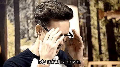 a man wearing glasses is covering his eyes with his hands while saying `` my mind is blown '' .