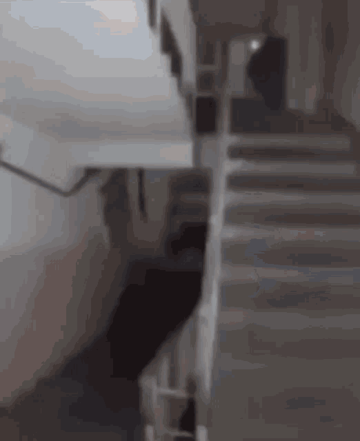 a blurry picture of a staircase with a person walking down it .