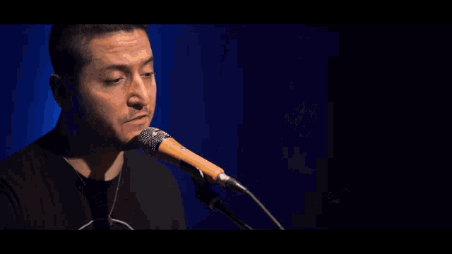 a close up of a person playing an acoustic guitar with the letter g on the neck