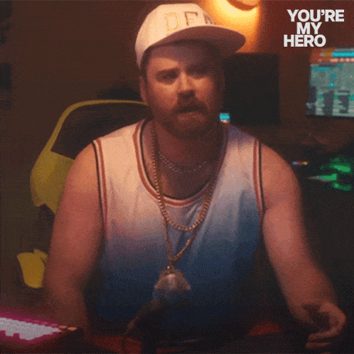 a man wearing a hat and a necklace says you have to dude