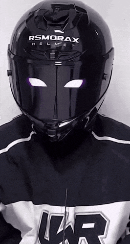 a person wearing a black helmet that says rsmorax helmet