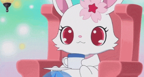 a white cat with a pink flower on its head is sitting in a pink chair holding a cup of tea .