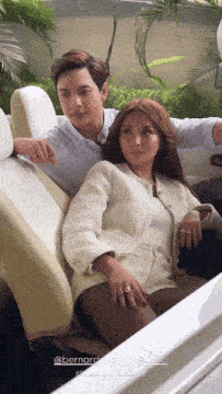 a man and a woman are sitting in a car with the words bernard on the bottom