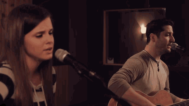 a woman singing into a microphone with a serious look on her face