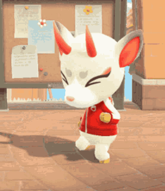 a white animal with red horns is standing on a tiled floor .