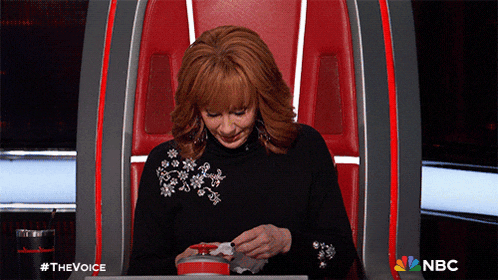 a woman is sitting in a chair with a nbc logo on the bottom