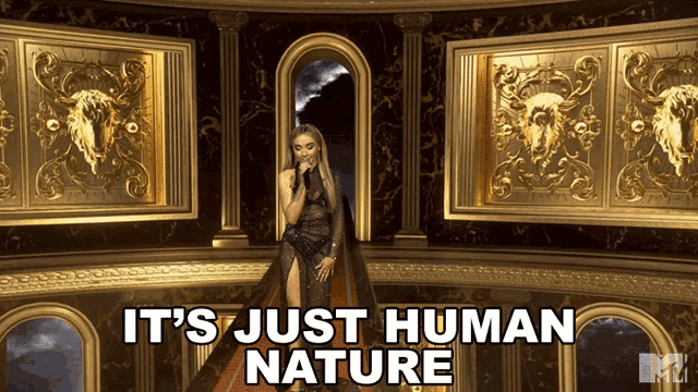 a woman singing into a microphone with the words it 's just human nature