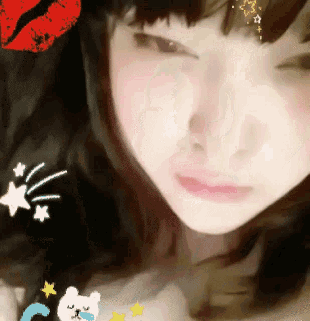 a close up of a woman 's face with stars and a red kiss on her forehead