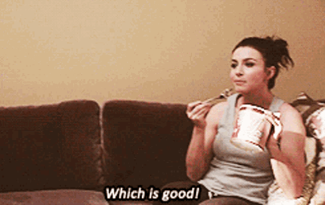 a woman is sitting on a couch eating ice cream and says which is good