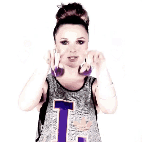 a woman with purple hair and a shirt that says t