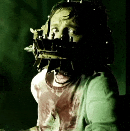a man wearing a mask with spikes on his head