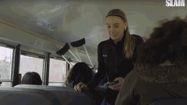 a woman on a bus with a sticker on the ceiling that says do not enter