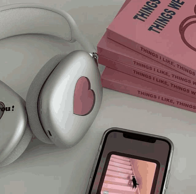 a pair of headphones sit next to a stack of things i like things