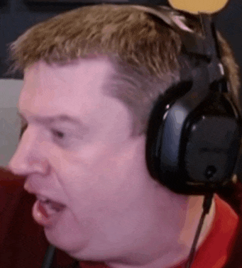 a man wearing headphones is making a funny face while playing a video game .