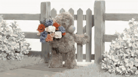 a teddy bear holding a bouquet of flowers is standing in front of a wooden fence