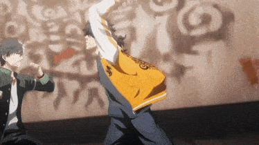 a couple of anime characters are fighting each other in front of a wall .