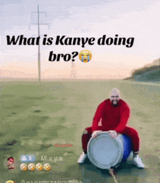 a man in a red shirt is sitting on a drum with the words what is kanye doing bro