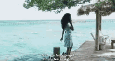 a woman standing on a dock talking on a cell phone with the words do you feel all right behind her