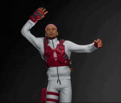 a man wearing a red vest with the word x on it stands with his arms in the air