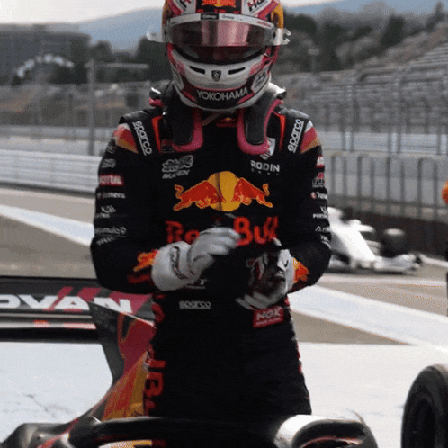 a man wearing a red bull helmet and a yokohama jacket