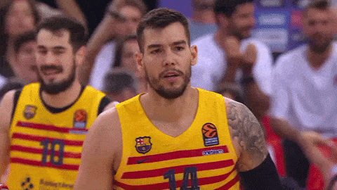 a basketball player wearing a yellow jersey with the number 14