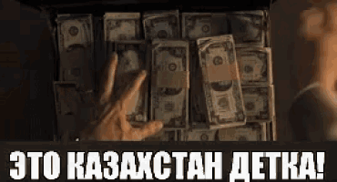 a hand is reaching for a stack of 20 dollar bills in a box