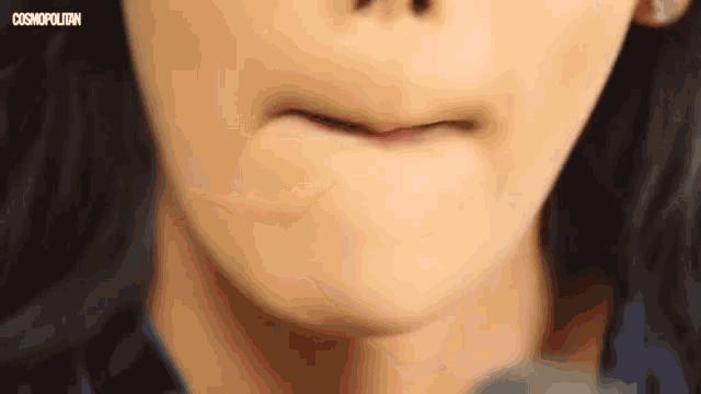 a close up of a woman 's mouth with the words cosmopolitan on the bottom .