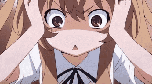 a girl in a school uniform is covering her ears with her hands and making a funny face .