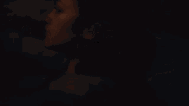 a naked woman is laying down in the dark