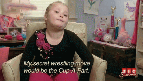 a little girl is sitting in a chair and talking about her secret wrestling move