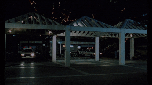 two toyota police cars are parked under a canopy at night
