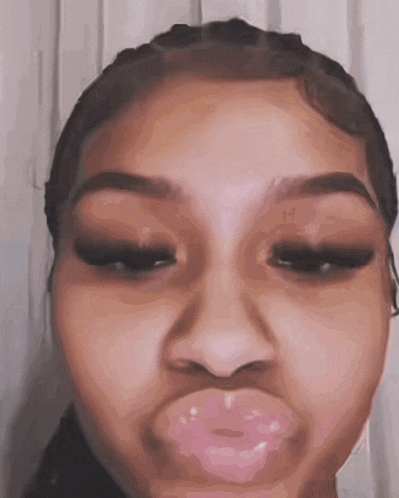 a close up of a woman making a funny face with her mouth open