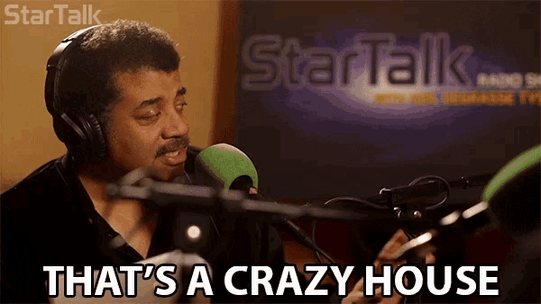 a man wearing headphones talking into a microphone with the words that 's a crazy house below him