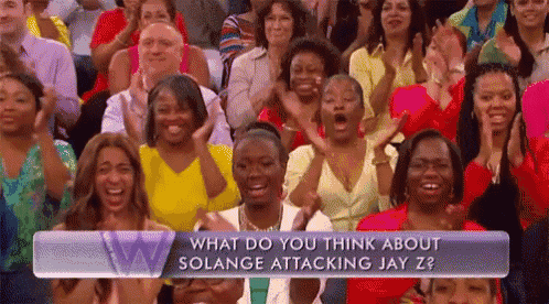 a crowd of people are sitting in front of a sign that says what do you think about solange attacking jay z