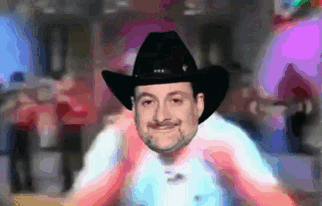 a man wearing a cowboy hat and a white shirt is smiling