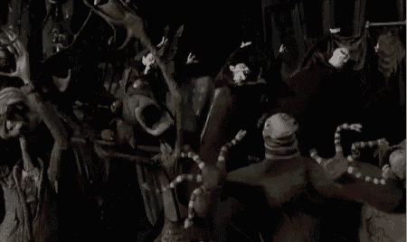 a group of monsters are standing next to each other in the dark .
