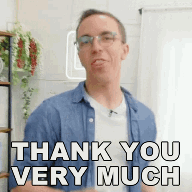 a man wearing glasses and a blue shirt is saying thank you very much .