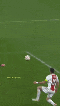 a soccer player in a red and white jersey kicks the ball
