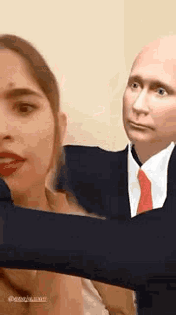 a man in a suit and tie is taking a selfie with a woman .