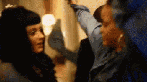 a couple of women are standing next to each other in a room .
