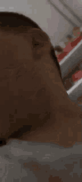 a close up of a person 's neck and ear with a white shirt on .