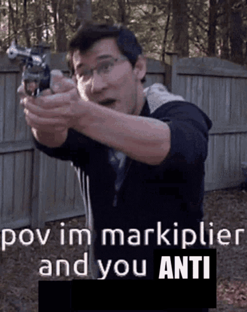 a man pointing a gun with the words " pov im markiplier and you anti " underneath him