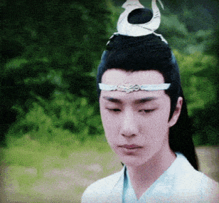 a young man wearing a white shirt and a headband with a bird on it .