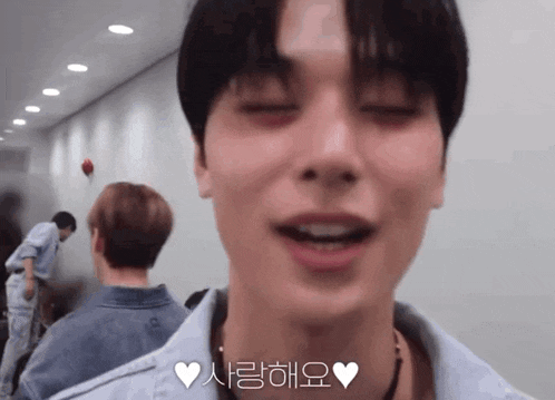a close up of a man 's face with his eyes closed and a heart in the corner