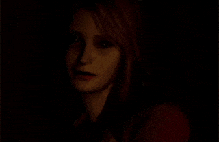 a woman in a red jacket is standing in a dark room .