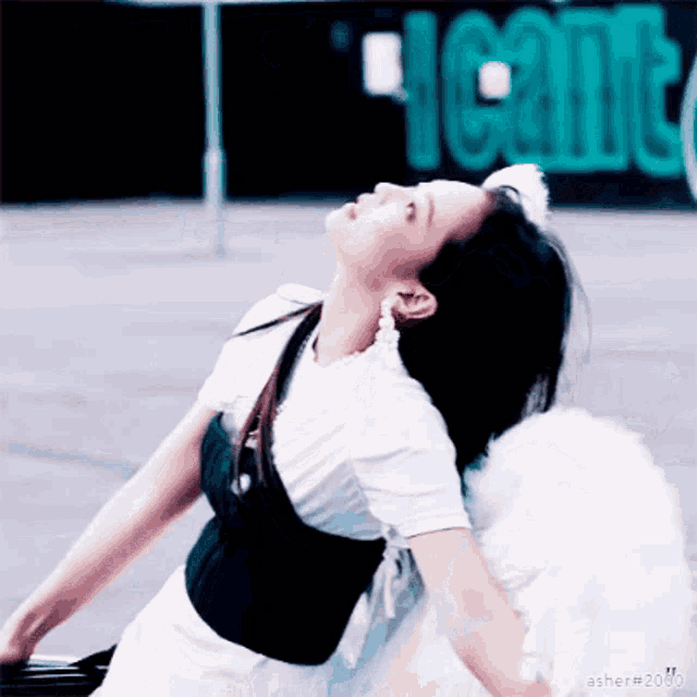 a woman in a white dress with white wings looks up