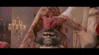 a woman is holding a monkey 's head in her hands .